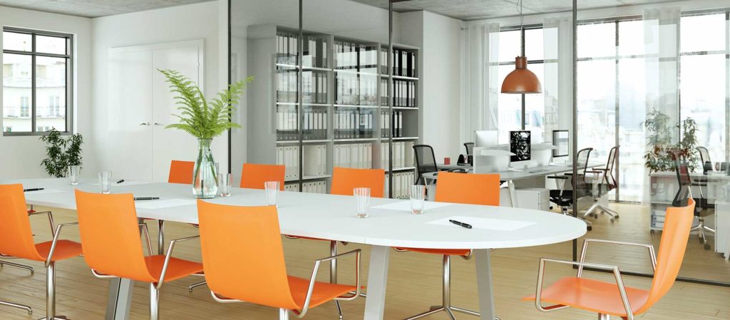 Modern office space with conference tables and orange chairs