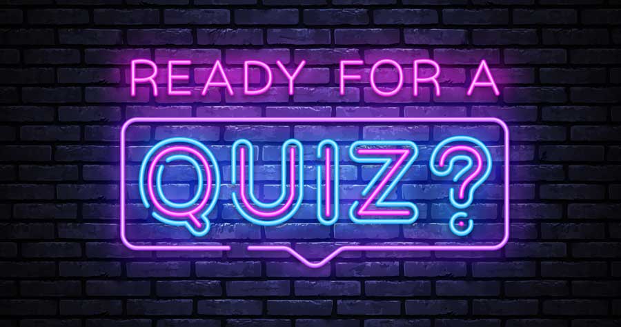 Brick wall with a neon sign saying "Ready for a Quiz?"