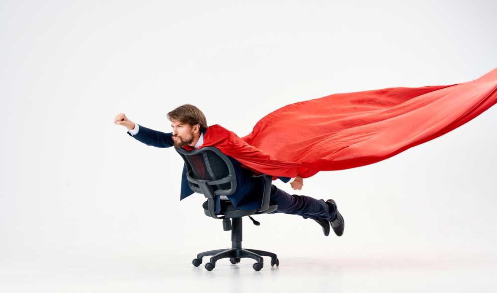 Man on office chair with a cape