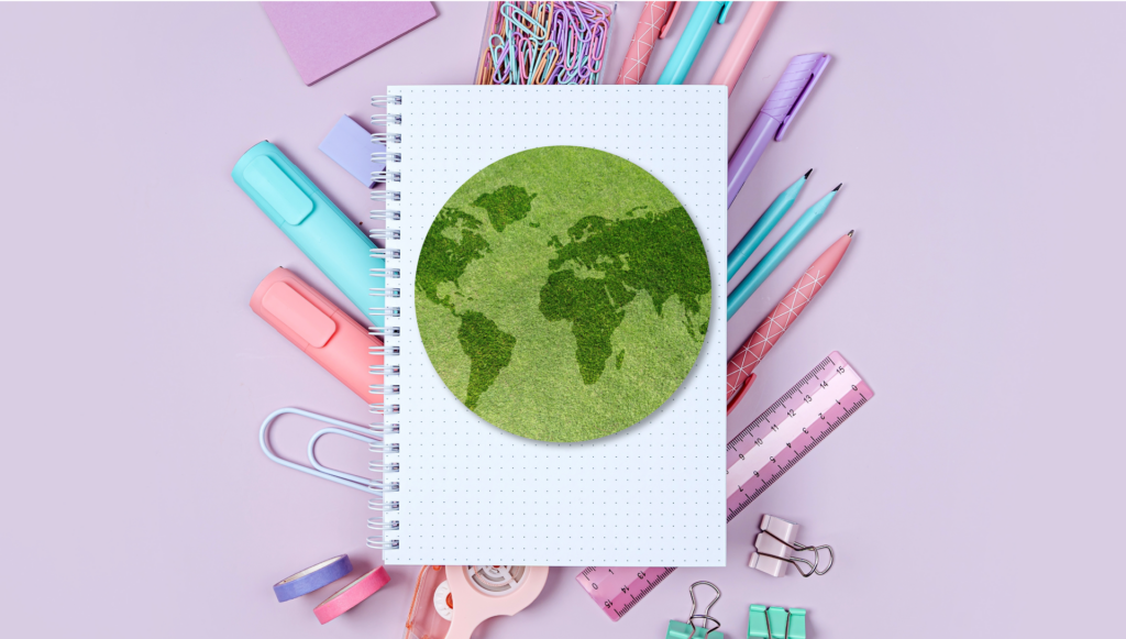 notebook with earth on tope of pastel stationary