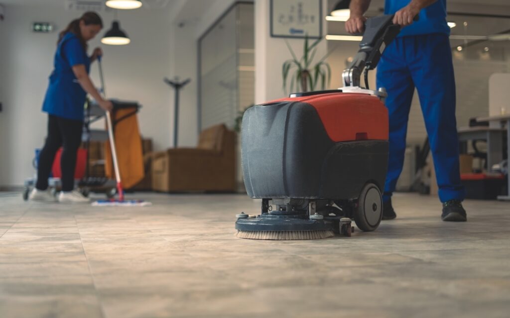 janitor using scrubber in an office