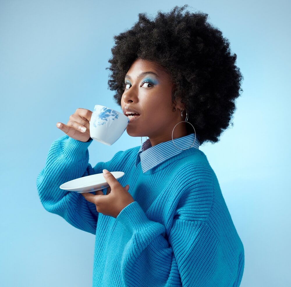 Fun woman drinking out of tea cup